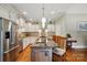 Spacious kitchen featuring a central island, stainless steel refrigerator, and bright, white cabinetry at 9950 Foil Rd, Mount Pleasant, NC 28124