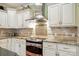 Close-up of a modern kitchen with stainless steel appliances, white cabinets, and granite countertops at 9950 Foil Rd, Mount Pleasant, NC 28124