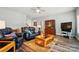 Open living room featuring hardwood floors, leather seating, and decorative cabinet at 9950 Foil Rd, Mount Pleasant, NC 28124