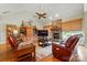 Inviting living room features a stone fireplace, hardwood floors, comfortable seating, and abundant natural light at 9950 Foil Rd, Mount Pleasant, NC 28124