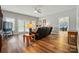Living room featuring hardwood floors, ceiling fan, leather recliners and french doors at 9950 Foil Rd, Mount Pleasant, NC 28124