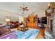 Cozy living room with vaulted ceiling, stone fireplace, and a wooden bookcase at 9950 Foil Rd, Mount Pleasant, NC 28124