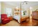 Bright main bedroom with hardwood floors, a four-poster bed, and plantation shutters at 9950 Foil Rd, Mount Pleasant, NC 28124