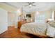 Elegant main bedroom featuring hardwood floors, plantation shutters, and tray ceiling at 9950 Foil Rd, Mount Pleasant, NC 28124