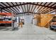 Outbuilding interior featuring tall ceilings, large doors, and ample storage space perfect for any hobbyist or professional at 9950 Foil Rd, Mount Pleasant, NC 28124