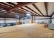 Vast metal warehouse with wooden floor, large roll-up door, and industrial-style ceiling beams at 9950 Foil Rd, Mount Pleasant, NC 28124