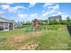 Spacious backyard featuring a wooden play structure and partial fencing at 10045 Carousel Corral Dr, Midland, NC 28107