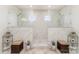 This modern bathroom features a marble-walled shower area with dual shower heads and natural light at 10045 Carousel Corral Dr, Midland, NC 28107