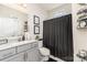 Modern bathroom featuring gray cabinets, a neutral countertop, and a window above the toilet for natural light at 10045 Carousel Corral Dr, Midland, NC 28107