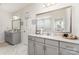This bathroom features dual vanities with grey cabinets, quartz counters, and marble floors at 10045 Carousel Corral Dr, Midland, NC 28107