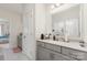 Well-lit bathroom boasts gray cabinetry, a large mirror, and a neutral color scheme for a serene ambiance at 10045 Carousel Corral Dr, Midland, NC 28107