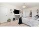 Bright bedroom featuring a modern dresser, TV, and stylish decor throughout the living space at 10045 Carousel Corral Dr, Midland, NC 28107