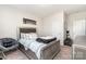 Comfortable bedroom with a bed, chair and a stylish gray color scheme throughout the living space at 10045 Carousel Corral Dr, Midland, NC 28107