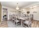 Dining room is decorated with a gray rug, wood floors, and a modern chandelier for an elegant touch at 10045 Carousel Corral Dr, Midland, NC 28107