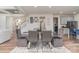 A spacious dining room features a glass table, comfortable gray chairs, and modern lighting at 10045 Carousel Corral Dr, Midland, NC 28107