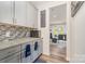 A stylish kitchen featuring gray cabinets, granite countertops, and a mosaic tile backsplash at 10045 Carousel Corral Dr, Midland, NC 28107