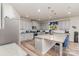 A well-lit kitchen featuring gray cabinets, stainless steel appliances, and a granite island with seating at 10045 Carousel Corral Dr, Midland, NC 28107
