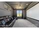 Home theater room featuring comfortable leather seating, a projector screen, and a window at 10045 Carousel Corral Dr, Midland, NC 28107