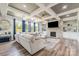 Cozy living room with a stone fireplace, built-in shelves, and large windows at 10045 Carousel Corral Dr, Midland, NC 28107