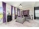This living room features plush carpet, lots of natural light, purple accents, and decorative wall at 10045 Carousel Corral Dr, Midland, NC 28107