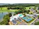 Aerial view of community amenities including swimming pools, tennis courts and clubhouse near the water at 106 Kent Ct, Mooresville, NC 28117