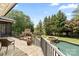 Beautiful backyard featuring a stone fireplace, pool, hot tub, and mature landscaping at 106 Kent Ct, Mooresville, NC 28117
