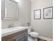 Modern bathroom with a wood vanity, stylish mirror, decorative art, and updated fixtures at 106 Kent Ct, Mooresville, NC 28117