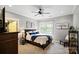 Serene bedroom with cozy decor, plush carpeting, large window, and a ceiling fan at 106 Kent Ct, Mooresville, NC 28117