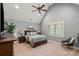 Comfortable bedroom with a vaulted ceiling, plush carpeting, natural light, and modern fixtures at 106 Kent Ct, Mooresville, NC 28117