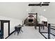 Spacious bonus room featuring high ceilings, a media center, game area, and modern decor at 106 Kent Ct, Mooresville, NC 28117