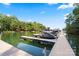 Private boat dock with multiple watercrafts and a picturesque view of the lake and surrounding trees at 106 Kent Ct, Mooresville, NC 28117