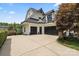 Spacious three-car garage with black doors and ample parking at 106 Kent Ct, Mooresville, NC 28117