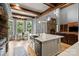 Spacious kitchen featuring a large island, stone fireplace, and access to the patio at 106 Kent Ct, Mooresville, NC 28117