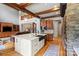 Open kitchen features a large island, wooden beams, and stainless steel appliances at 106 Kent Ct, Mooresville, NC 28117