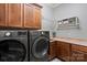 Convenient laundry room with modern washer and dryer, storage cabinets, and countertop at 106 Kent Ct, Mooresville, NC 28117