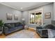 Comfortable living room with hardwood floors, neutral color scheme, and window with backyard view at 106 Kent Ct, Mooresville, NC 28117
