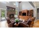 Cozy living room with stone fireplace, built-in shelves, and hardwood floors at 106 Kent Ct, Mooresville, NC 28117