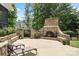 Outdoor living space featuring an impressive stone fireplace and lounge chairs for relaxing at 106 Kent Ct, Mooresville, NC 28117