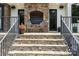 Charming stone porch featuring chairs, flower pot, and stone steps leading to the backyard at 106 Kent Ct, Mooresville, NC 28117