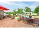 Outdoor patio area features brick paving, an umbrella-covered table, and views of the in-ground pool and landscaped yard at 111 Gordon Ave, Shelby, NC 28152