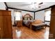 Spacious bedroom features hardwood floors, a wooden bed frame, two windows and a ceiling fan at 111 Gordon Ave, Shelby, NC 28152