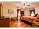 Comfortable bedroom features hardwood floors, a ceiling fan, curtains and bedside furnishings at 111 Gordon Ave, Shelby, NC 28152
