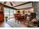 Warm dining room featuring a stone fireplace, wood floors, and glass doors leading to the outdoors at 111 Gordon Ave, Shelby, NC 28152