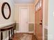 Inviting foyer features a round mirror, a wooden accent table, and a decorative rug on the ceramic tile floor at 111 Gordon Ave, Shelby, NC 28152