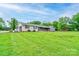 Expansive front yard showing a brick and stone home with an attached garage on a lush green lawn at 111 Gordon Ave, Shelby, NC 28152