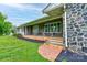 Inviting front porch with stone accents and brick stairs leading up to a charming seating area at 111 Gordon Ave, Shelby, NC 28152