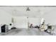 Spacious garage featuring white walls, concrete floors, storage, and three ceiling fans for comfort and functionality at 111 Gordon Ave, Shelby, NC 28152