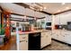 Open kitchen with white cabinetry, granite countertops, and a central island with black appliances at 111 Gordon Ave, Shelby, NC 28152