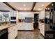Well-equipped kitchen with white cabinets, granite counters, mosaic backsplash, and modern appliances at 111 Gordon Ave, Shelby, NC 28152