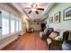 Bright living room features hardwood floors, ceiling fan, large windows, and comfortable seating area at 111 Gordon Ave, Shelby, NC 28152
